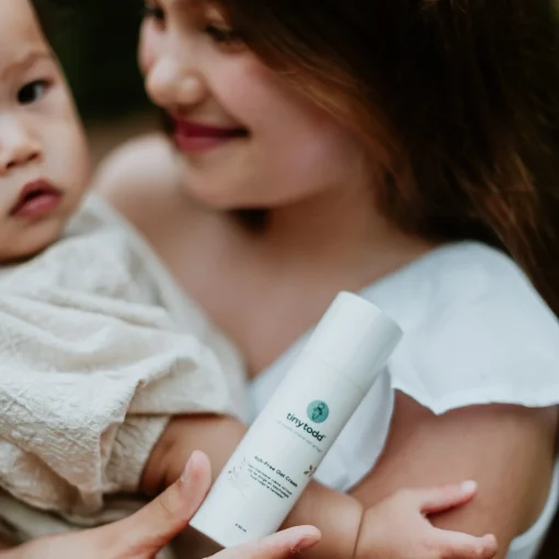 moeder en baby met de havercreme in handen